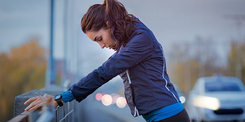 woman running and stretching