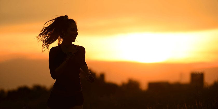 Silhouette of a woman running at sunset