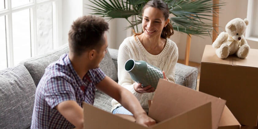 young couple unpacking new home