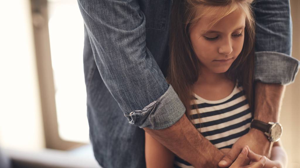 father embracing daughter