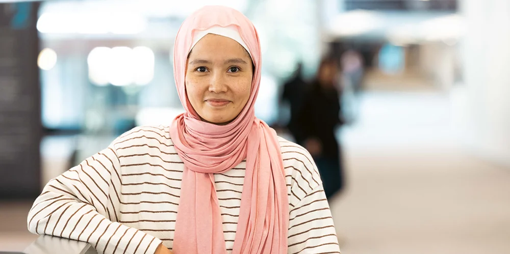 Female actuary wearing stripy shirt smiling