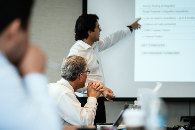 Man presenting at conference.