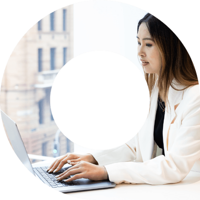 Young woman wearing white suit jacket typing on laptop in viewfinder shape