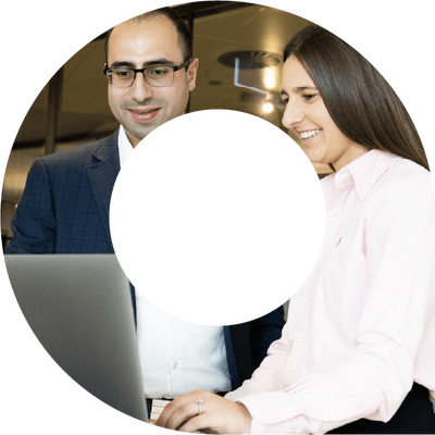 Man and a woman typing on a laptop smiling