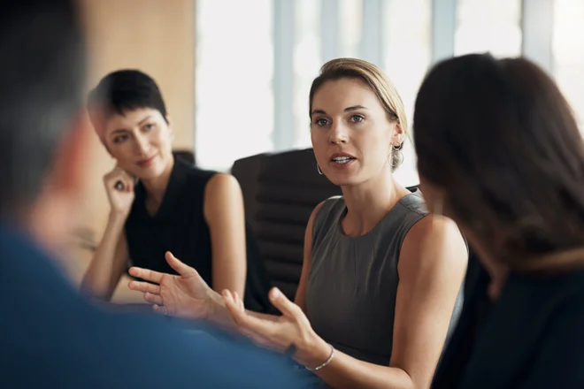 Business woman engaged in team discussion.