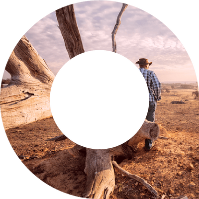 Farmer leaning against a tree in drought within viewfinder shape