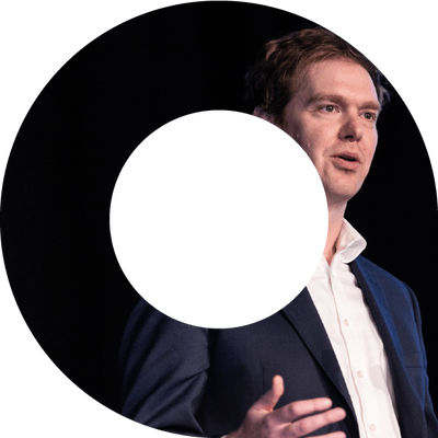 Actuary speaking on stage at an event in a viewfinder shape