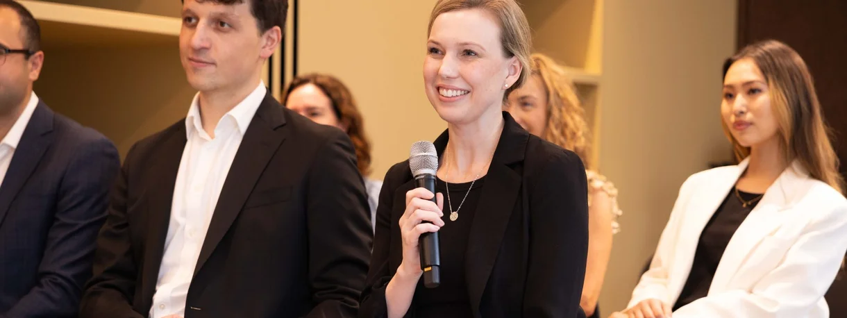 A photo of corporate professionals engaging in a forum.