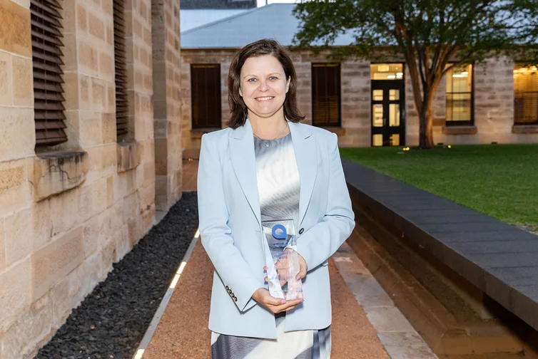 Alissa Holz holding President's Award at the 2024 Volunteer of the Year awards