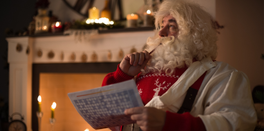 Santa Claus at Home resting near fireplace, doing Sudoku