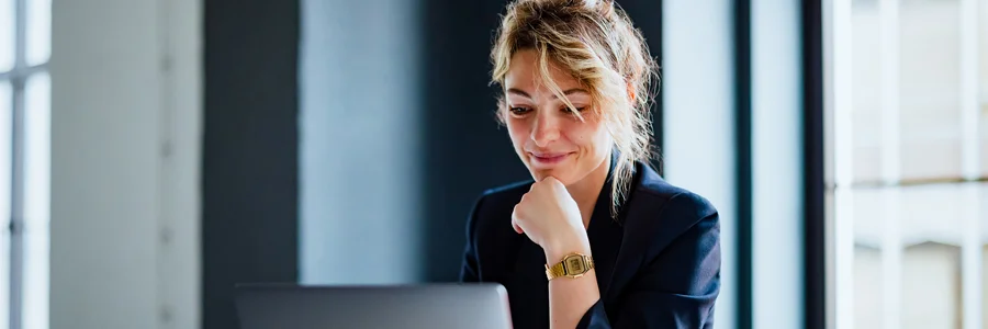 Woman sitting and looking at laptop