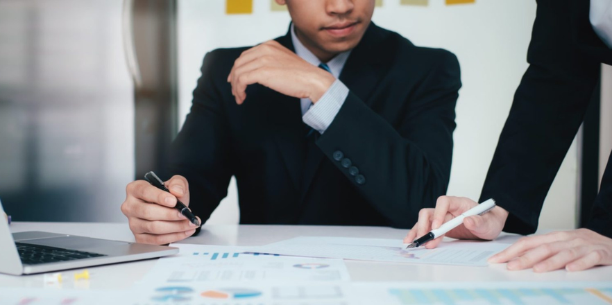 Business discussion between two people showing each other some documents