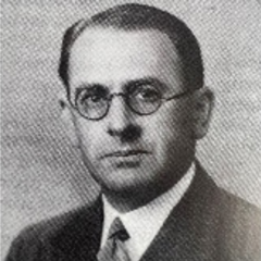 A black and white photo of a professional man wearing glasses.