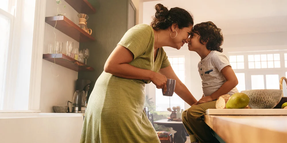 Mother and child in a kitchen embracing