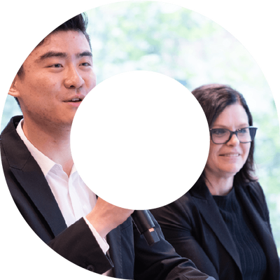A man and a woman at a conference event within a viewfinder shape