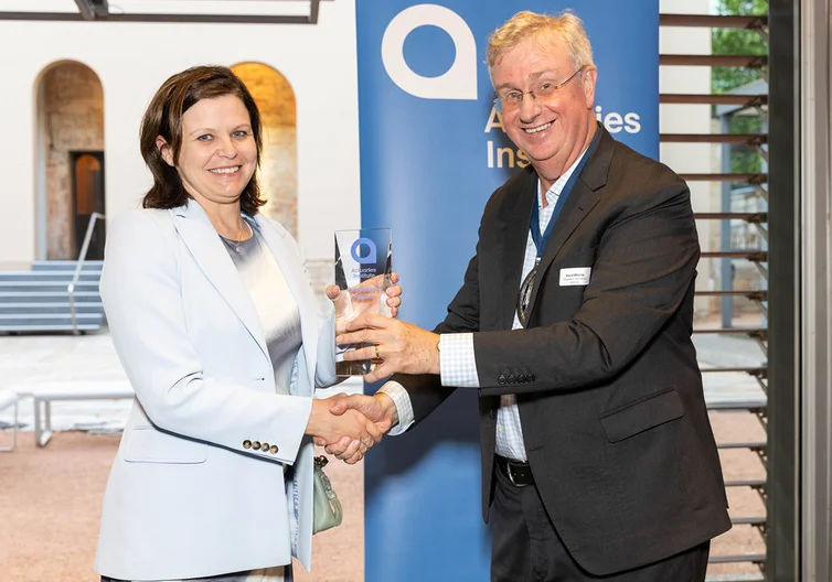 Volunteer of the Year award winner Alissa Holz receiving award from David Whittle at the 2024 award ceremony