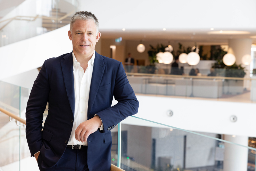 Man in business suit leaning on bannister
