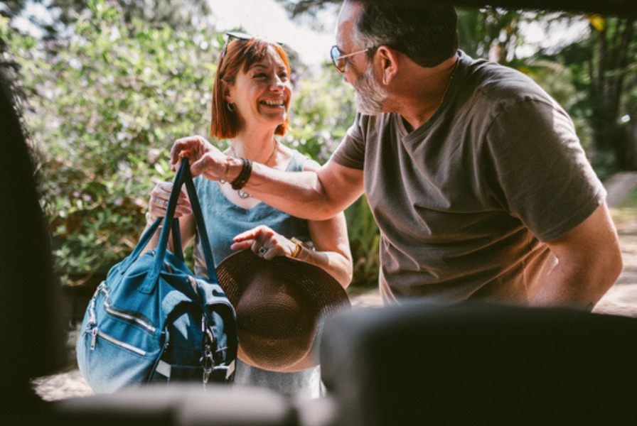 Middle-aged couple, preparing for a trip.