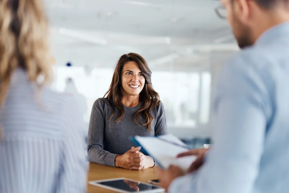 Young candidate talking to human resource team during a job interview in the office.