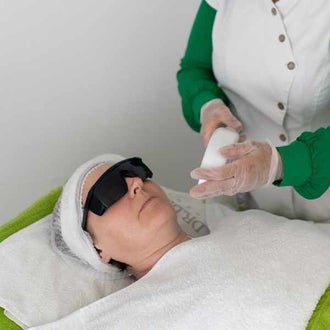 Woman getting facial laser hair removal. Laser hair removal is fine for those without a history of skin cancer.