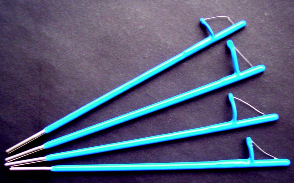 4 blue pieces of metal with loop and gold on end used for Colposcopy.