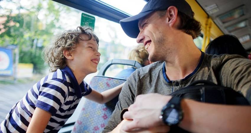 Father and son on a bus.