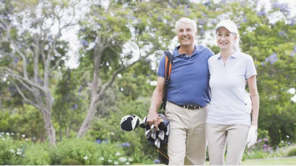 Happy couple on golf course.