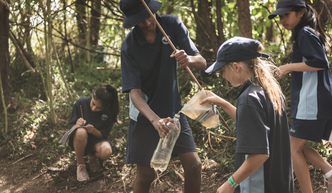 Northcross Intermediate School students carefully collect and measure out water samples, using their Freshwater Detectives Kit. Sample is taken from taken their local stream in Sherwood Reserve.