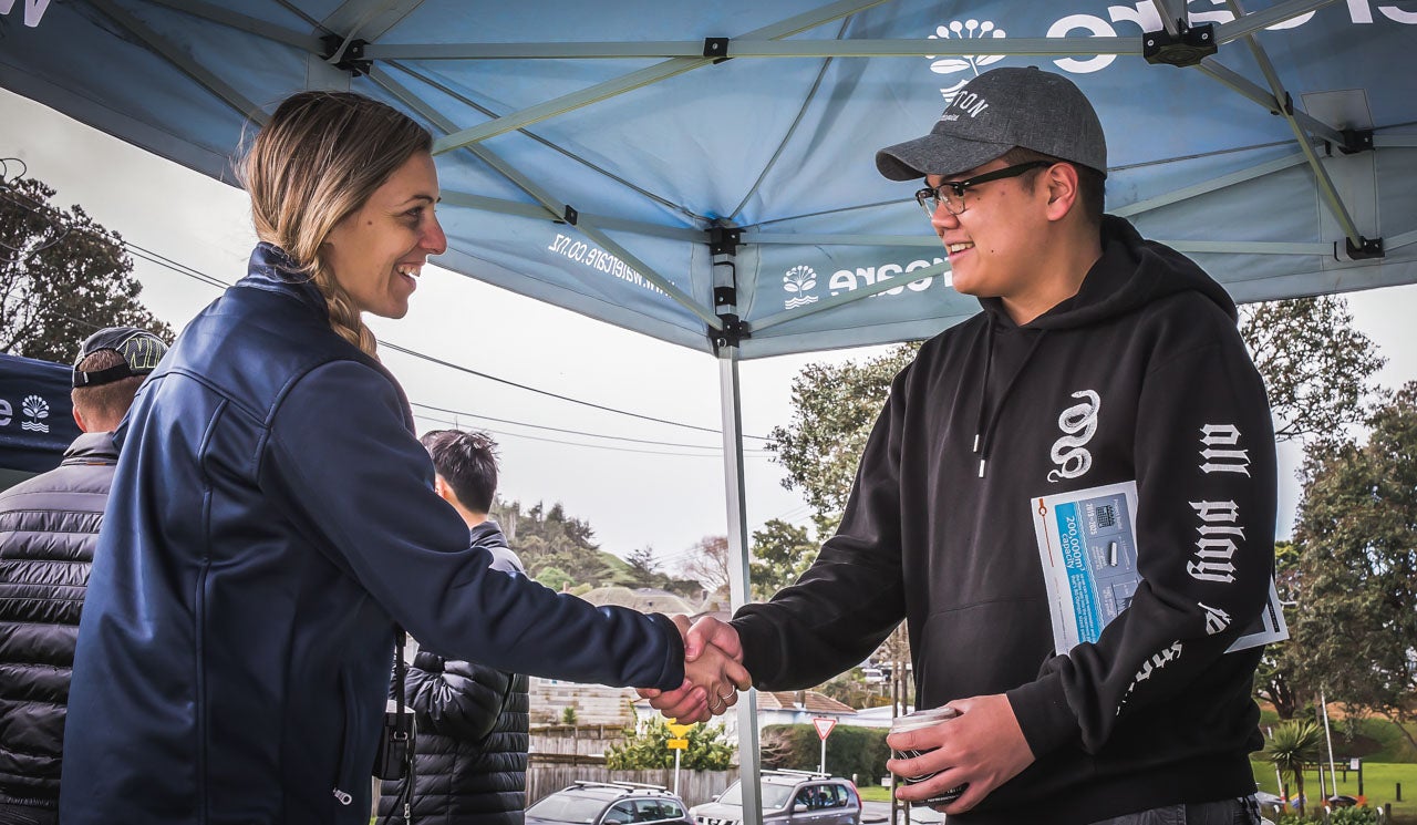 Stakeholder liaison advisor, Jennifer Charteris shakes the hand of a resident at an open day. They share information and their interest in a local infrastructure project.