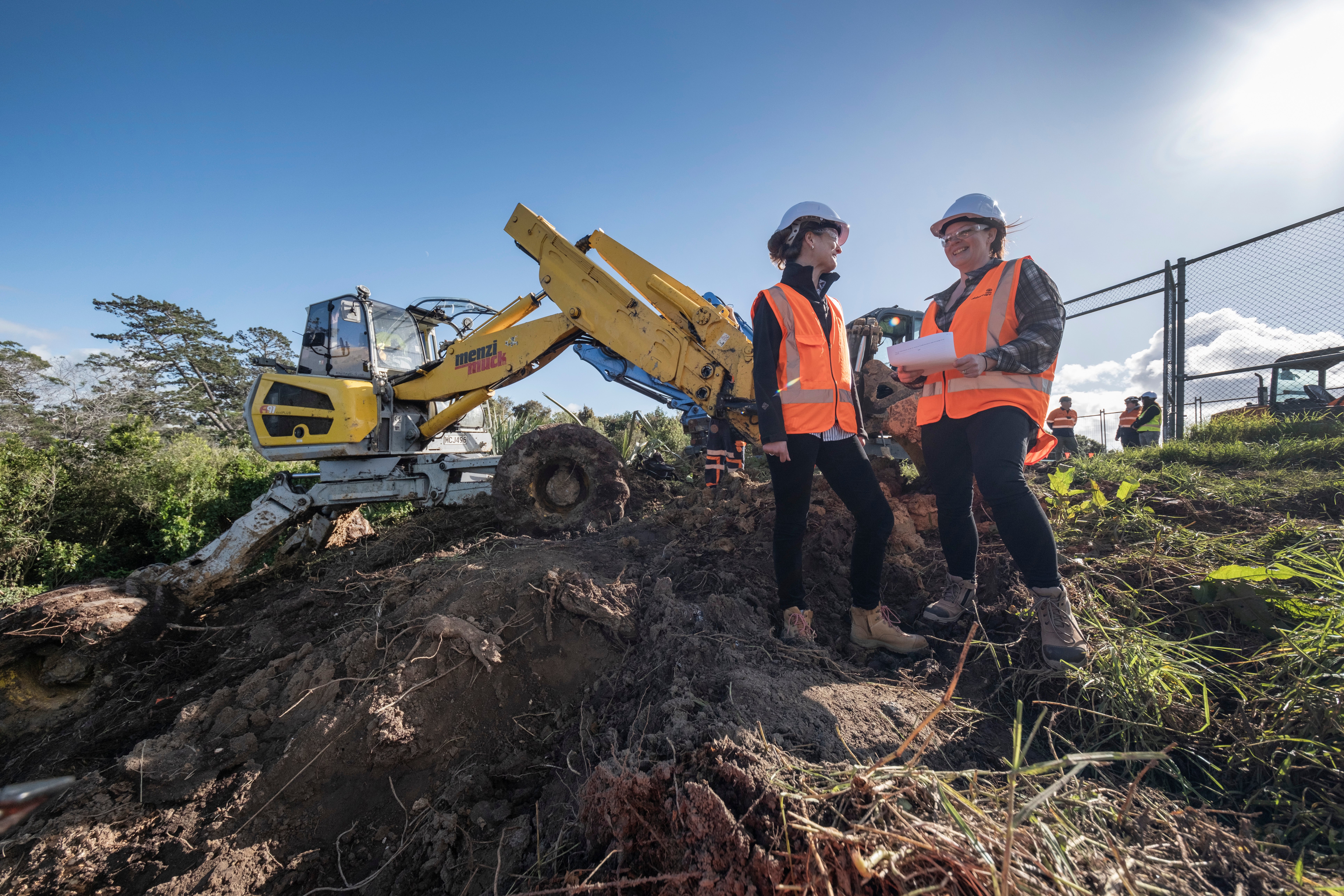 Watercare project manager Monica Paterson and flood recovery manager Suzanne Lucas with the spider digger at a Birkenhead slip