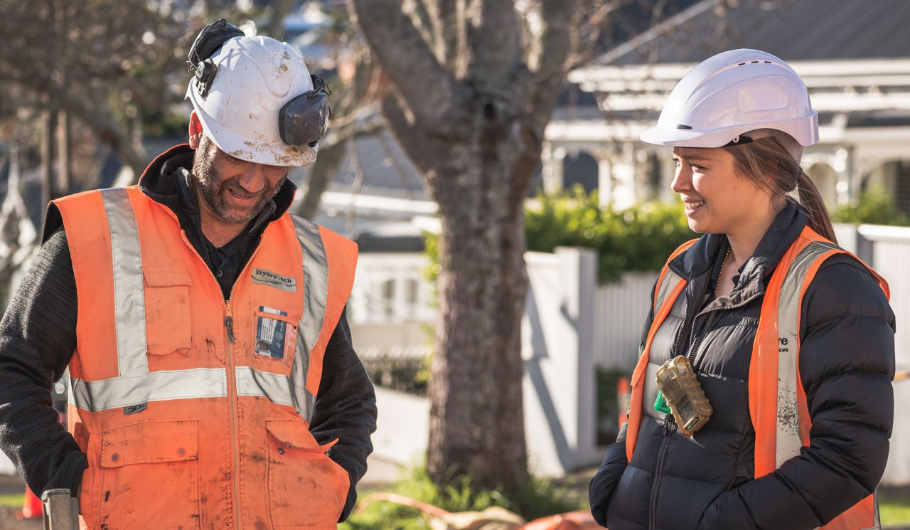 Sophie discusses an active pipework project with a contractor onsite in Ponsonby.