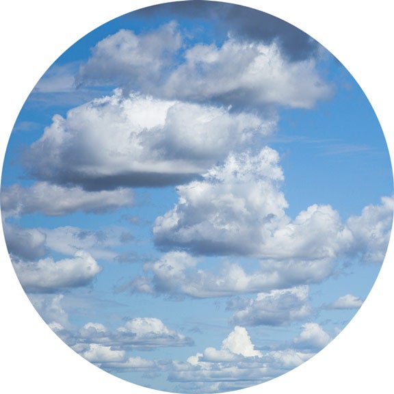 Image of white cumulus clouds gathering and forming in the foreground and stretching far into the distance of an otherwise blue sky.