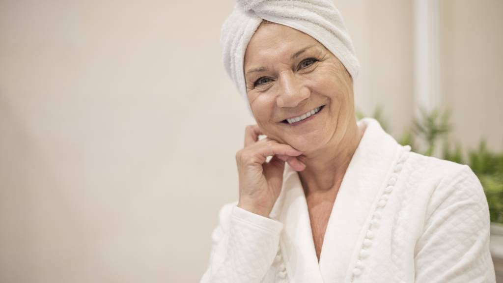 Senior woman with towel on her head, out of the shower