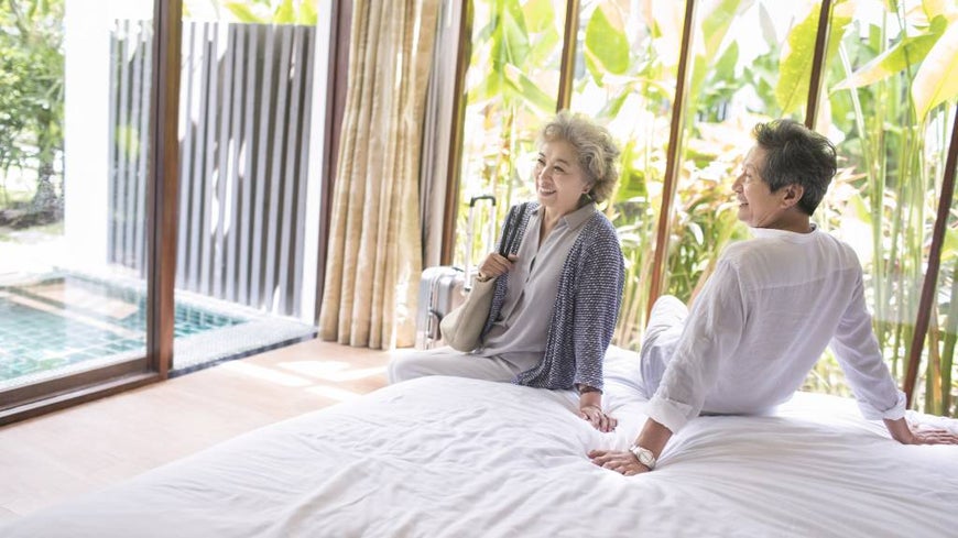 A SENIOR COUPLE RELAXES IN A RESORT STYLE RETIREMENT HOME