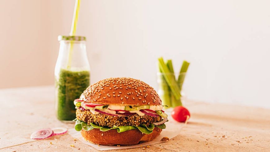 Vegan burger with asparagus spears and green smoothie