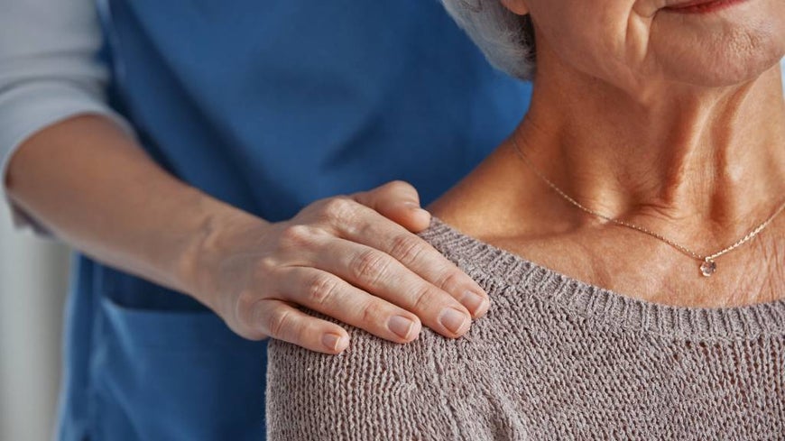 Nurse comforts senior woman