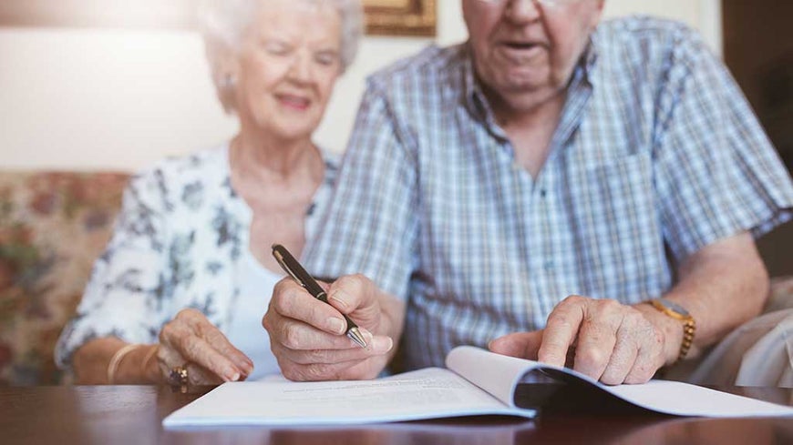 older couple planning at table