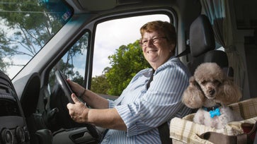 Image of Sister Christine Henry, driving with her poodle.