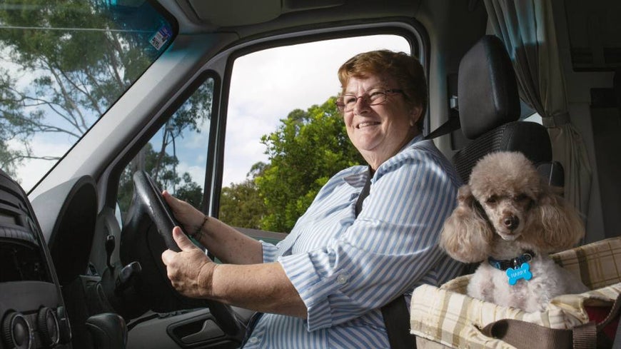 Image of Sister Christine Henry, driving with her poodle. 