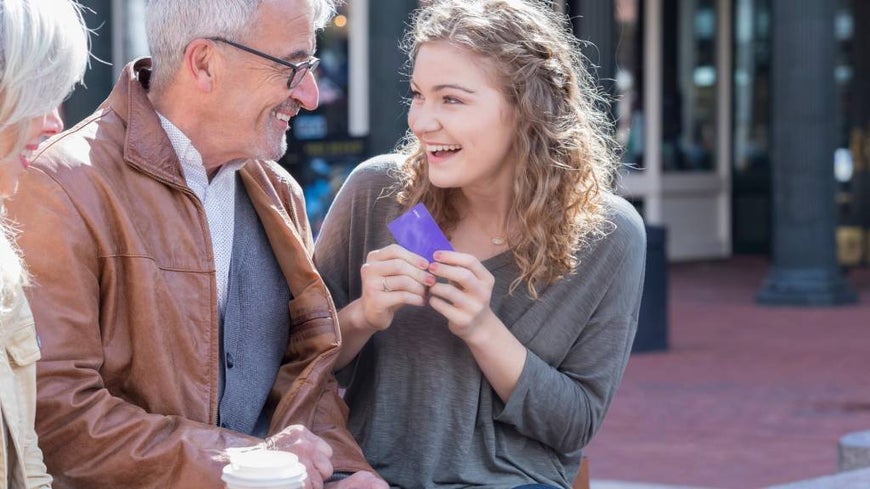 Young woman receives credit card from grandparents 