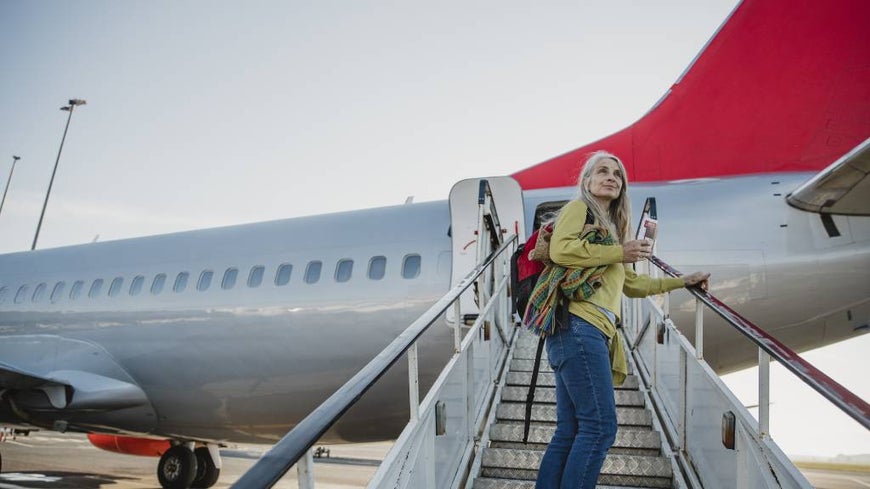 shy woman boarding plane