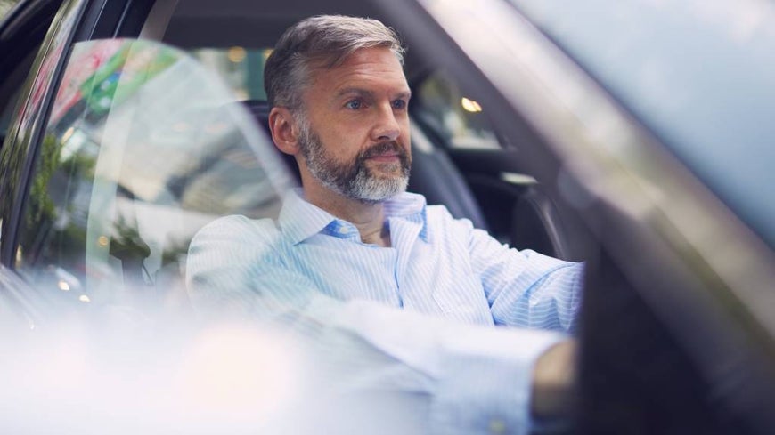 older man driving car