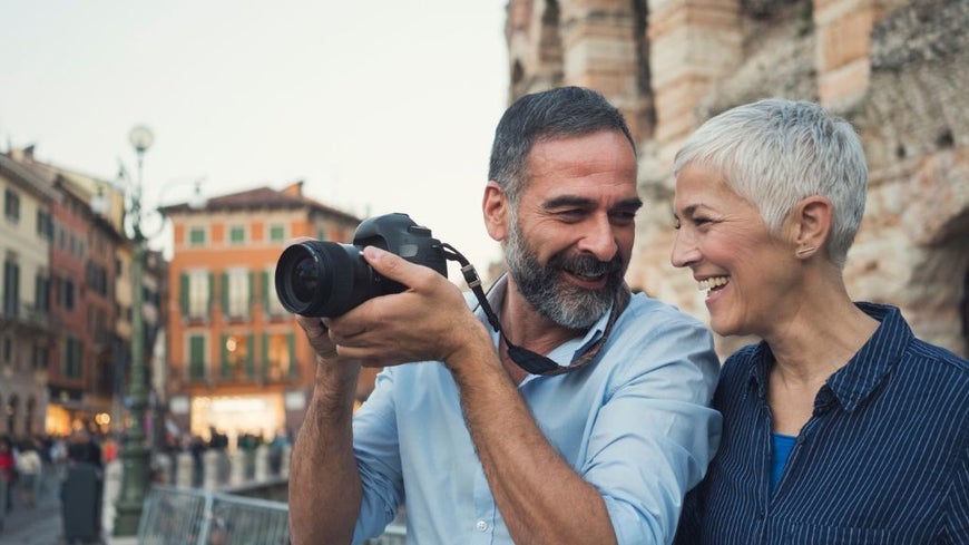 older couple on holidays with camera