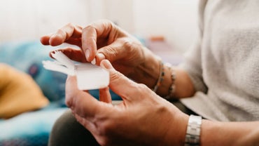 Senior woman with pill case and prescription medicine
