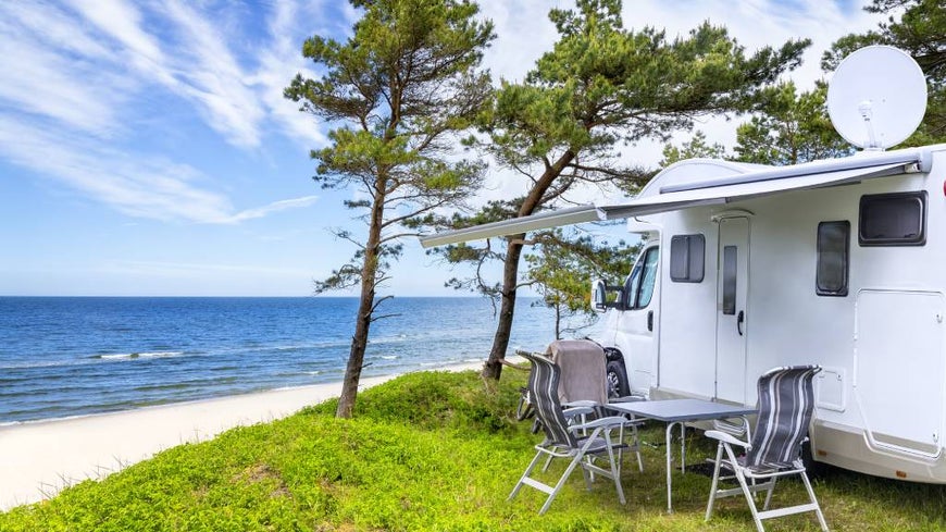 Caravan at a caravan park with table and chairs set out