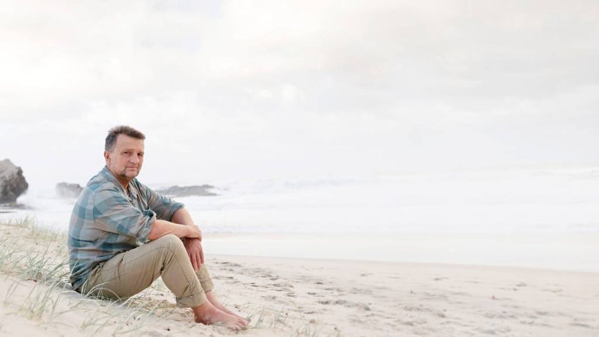Tim Baker pictured on a beach