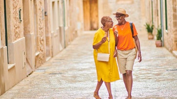 Senior couple travels in bright clothes