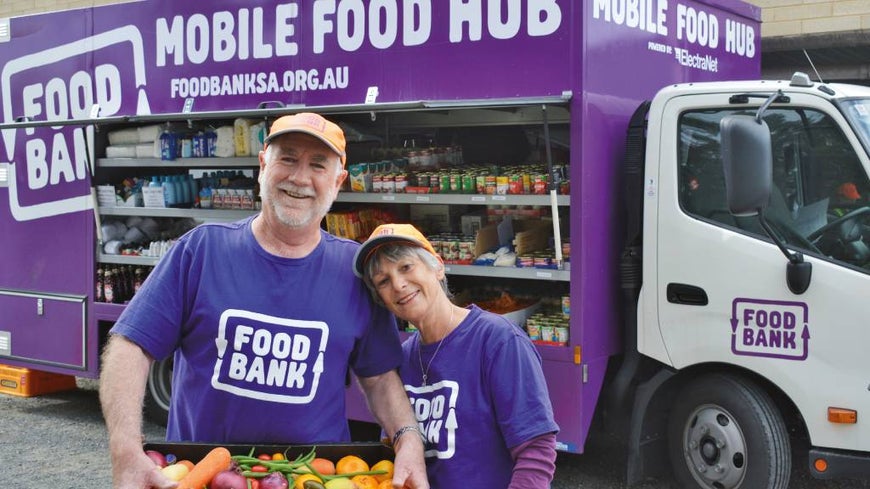 Seniors volunteering with Mobile Food Hub delivery truck.