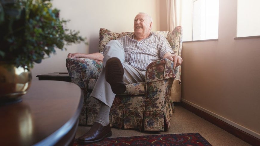 man sitting on couch at home