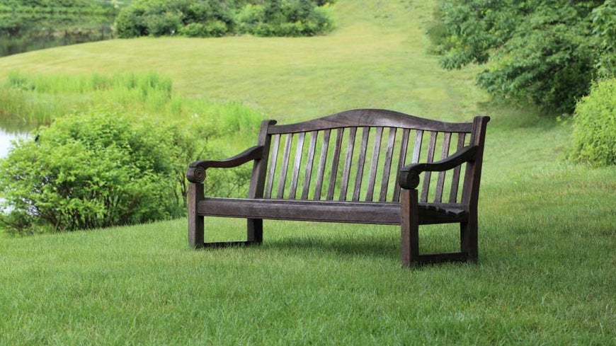 Memorial funeral bench in green grassy park